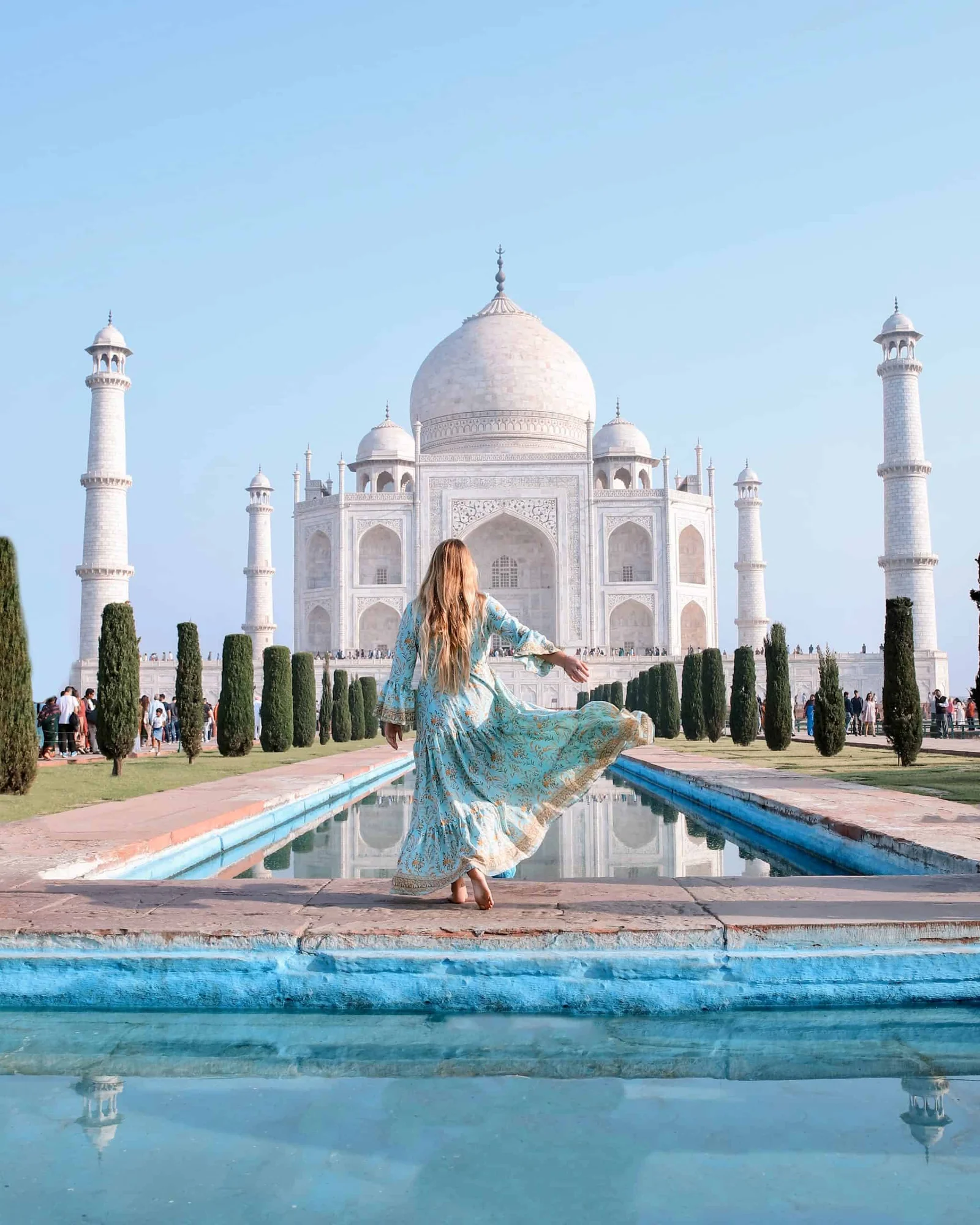 Guide explaining the Taj Mahal to travelers