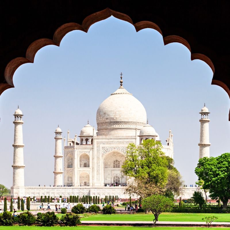 Visitors walking toward the Taj Mahal at midday